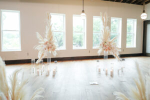 Modern and Timeless Black and White Wedding Ceremony Decor, Black Chairs, White and Blush Pink Roses Flowers and Pampas Grass Arrangements on Tall Clear Glass Vases, Hurricane Vases with Candles in Aisle | Tampa Bay Wedding Photographer Lifelong Photography Studio | Wedding Venue Oxford Exchange