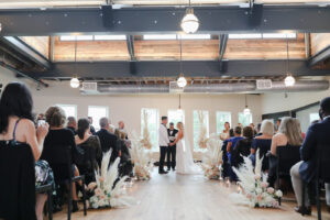 Modern and Timeless Black and White Wedding Ceremony, Bride and Groom Exchanging Wedding Vows, White and Blush Pink Roses with Pampas Grass Floral Arrangement | Tampa Bay Wedding Photographer Lifelong Photography Studio | Wedding Venue Oxford Exchange