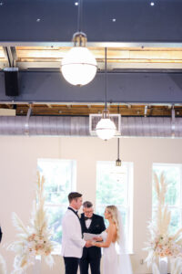 Modern and Timeless Black and White Wedding Ceremony, Bride and Groom Exchanging Wedding Vows, White and Blush Pink Roses with Pampas Grass Floral Arrangement | Tampa Bay Wedding Photographer Lifelong Photography Studio | Wedding Venue Oxford Exchange
