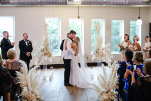 Modern and Timeless Black and White Wedding Ceremony, Bride and Groom Exchanging Wedding Vows, White and Blush Pink Roses with Pampas Grass Floral Arrangement | Tampa Bay Wedding Photographer Lifelong Photography Studio | Wedding Venue Oxford Exchange
