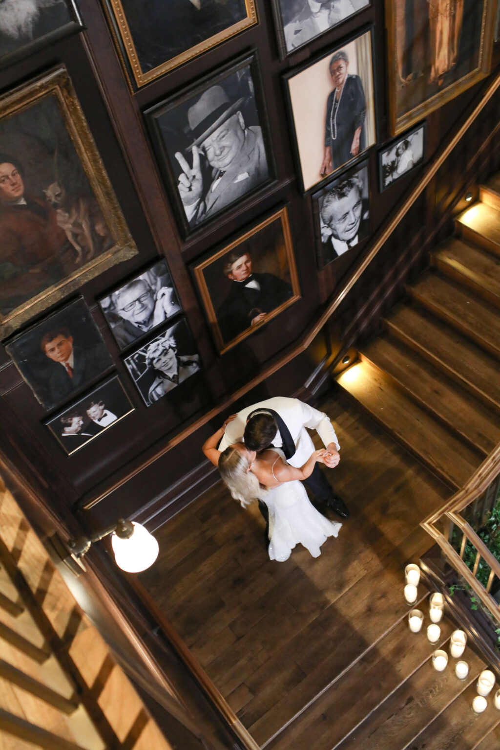 Modern Timeless Black and White Wedding, Bride Wearing Fitted Sequin Wedding Dress and Groom Wearing White and Black Tuxedo Climbing Staircase at Wedding Venue Oxford Exchange | Tampa Bay Wedding Photographer Lifelong Photography Studio