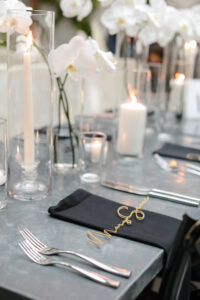 Modern and Timeless Black and White Wedding Reception Decor, Black Linen Napkin, Gold Laser Cut Name Place Card, White Orchids, Candles | Tampa Bay Wedding Photographer Lifelong Photography Studio