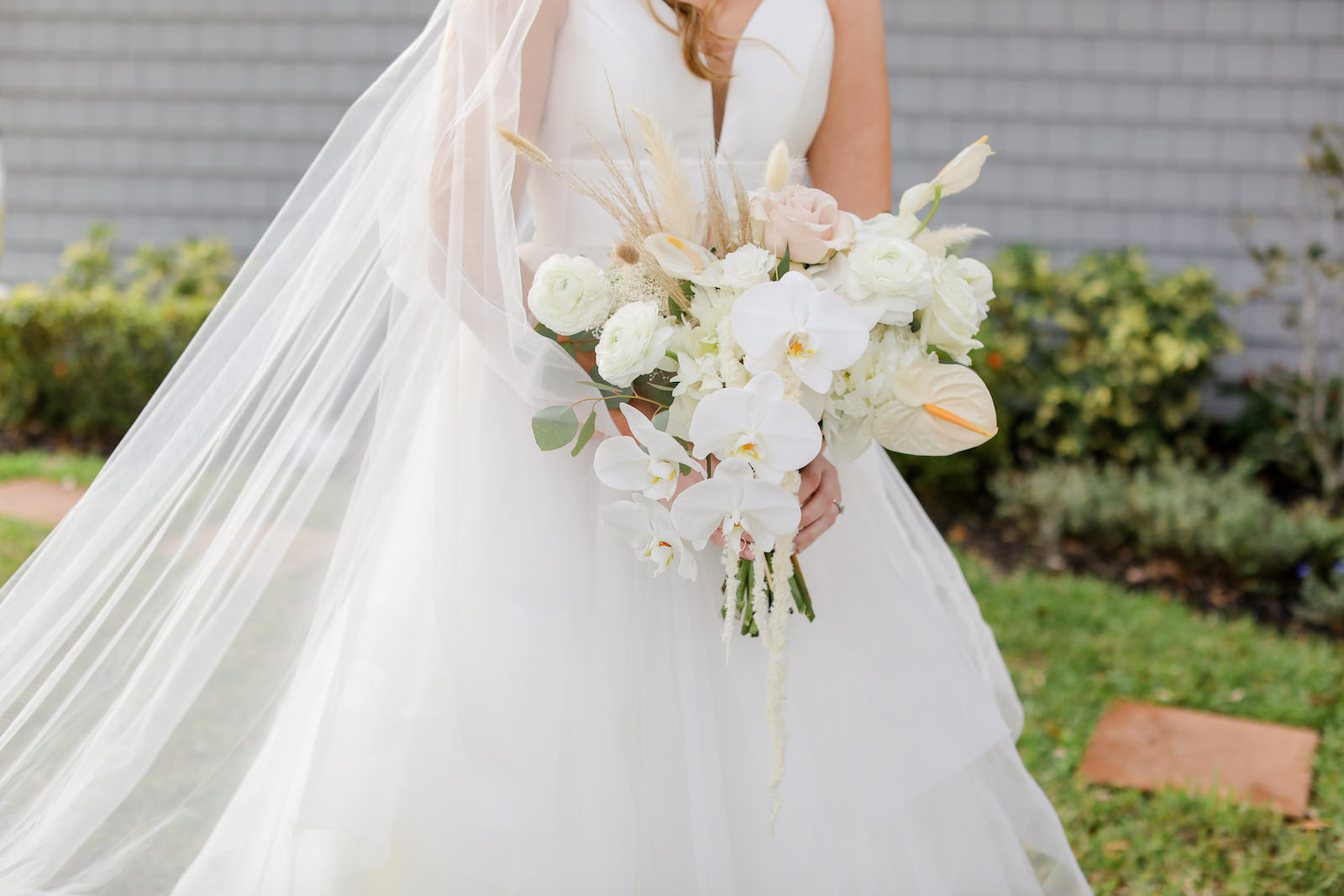 Romantic Blue Coastal Chic Wedding, Bride Holding White Orchids, Blush Pink and White Roses, Anthurium, Hanging Amaranthus, Pampas Grass Floral Bouquet | Tampa Bay Wedding Photographer Lifelong Photography Studio