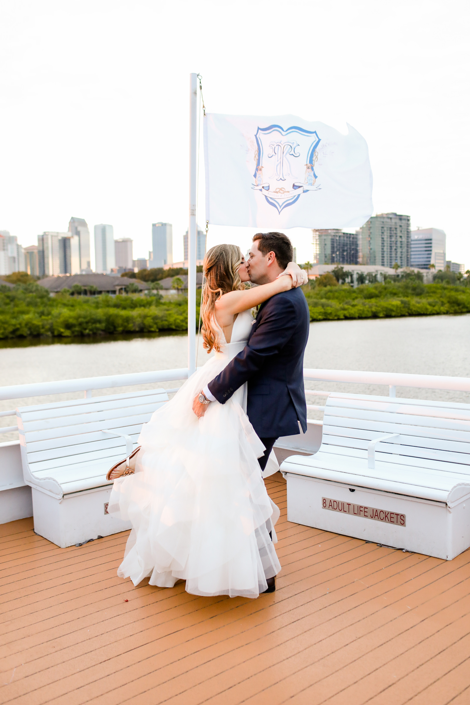 Romantic Blue Coastal Chic Tampa Wedding, Bride Being Twirled by Groom | Tampa Bay Wedding Venue Yacht StarShip | Wedding Photographer Lifelong Photography Studio