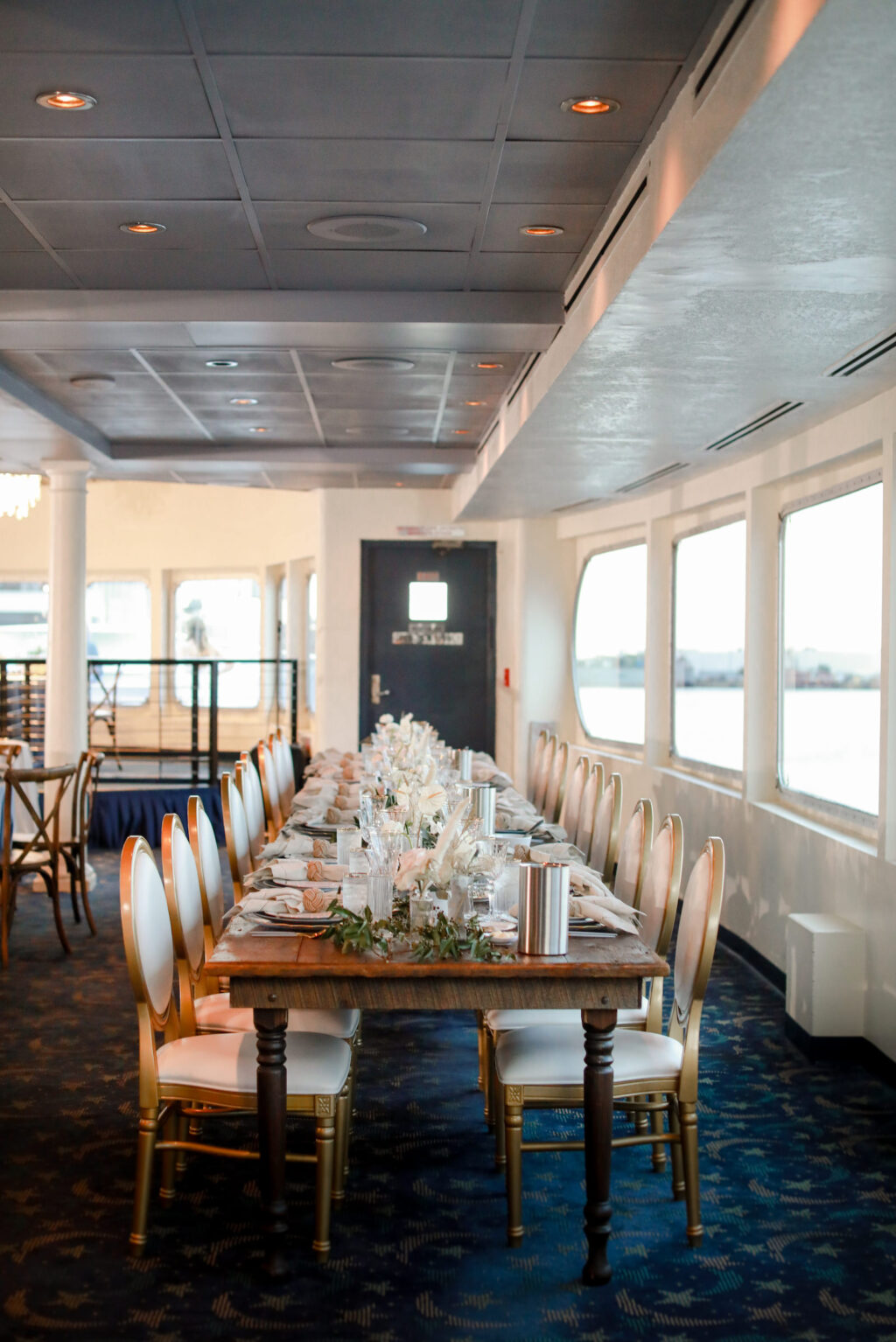 Romantic Nautical Coastal Reception with Long Wooden Farm Table, King Louis Chairs and Low Centerpieces | Downtown Tampa Wedding Venue Yacht Starship | Kate Ryan Event Rentals