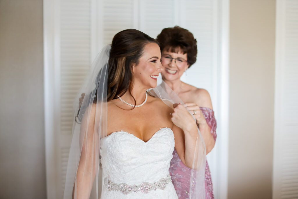 Romantic Classic Bride in Strapless Lace and Rhinestone Belt Wedding Dress Getting Wedding Ready with Mother of the Bride | Tampa Bay Wedding Photographer Lifelong Photography Studio | Wedding Hair and Makeup Michele Renee the Studio | Wedding Dress Truly Forever Bridal