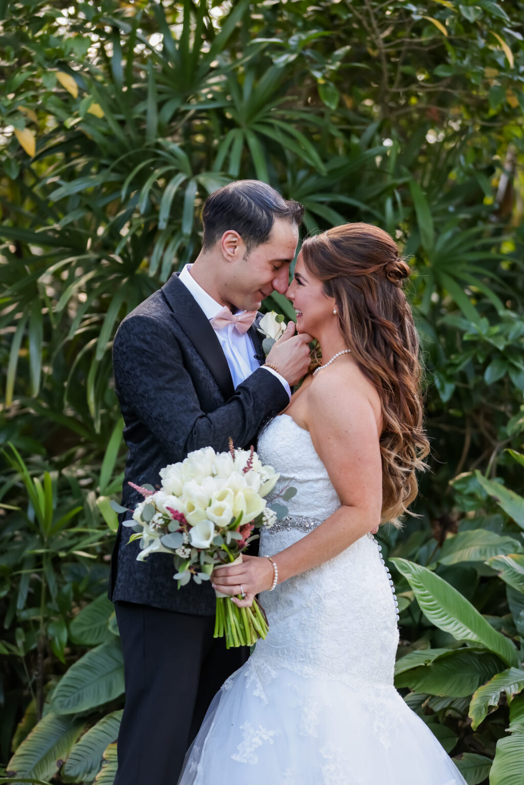 Romantic Classic Bride Holding White Roses and Eucalyptus Floral Bouquet, First Look with Groom in Garden | Tampa Bay Wedding Photographer Lifelong Photography Studio | Wedding Hair and Makeup Michele Renee the Studio | Wedding Dress Truly Forever Bridal