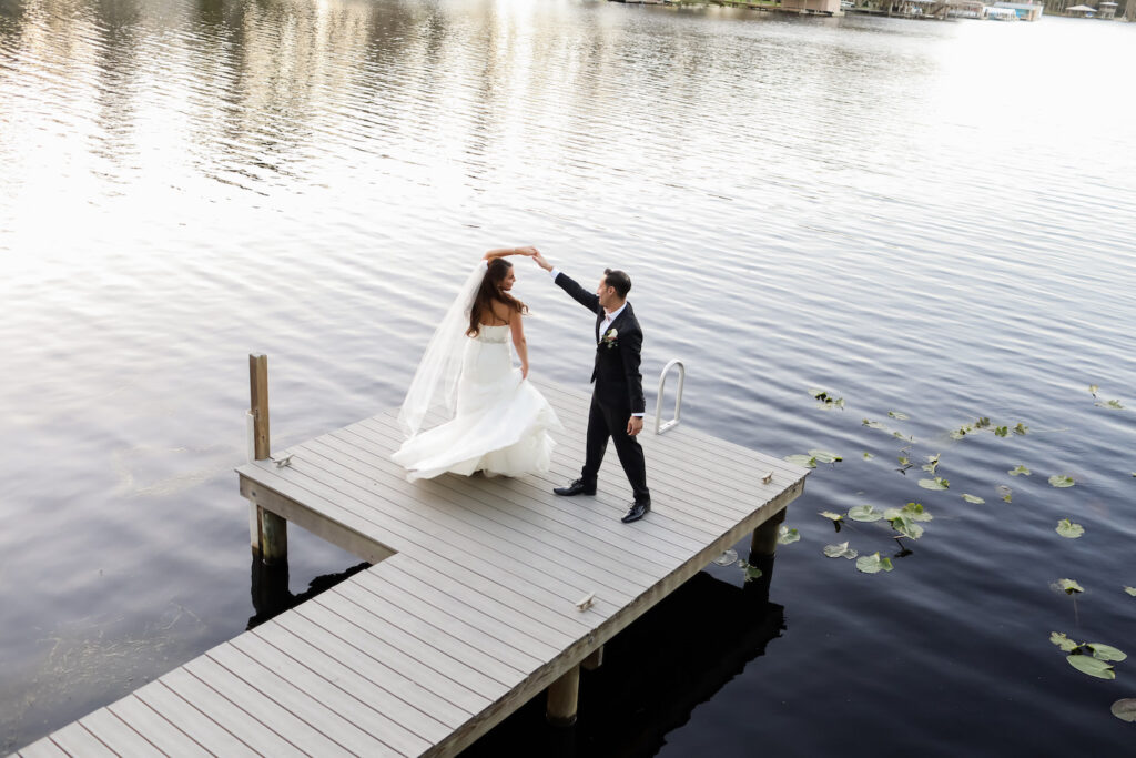 Romantic Groom Twirling Bride On Boat Dock | Tampa Bay Wedding Photographer Lifelong Photography Studio | Wedding Dress Truly Forever Bridal | Planner Special Moments Event Planning