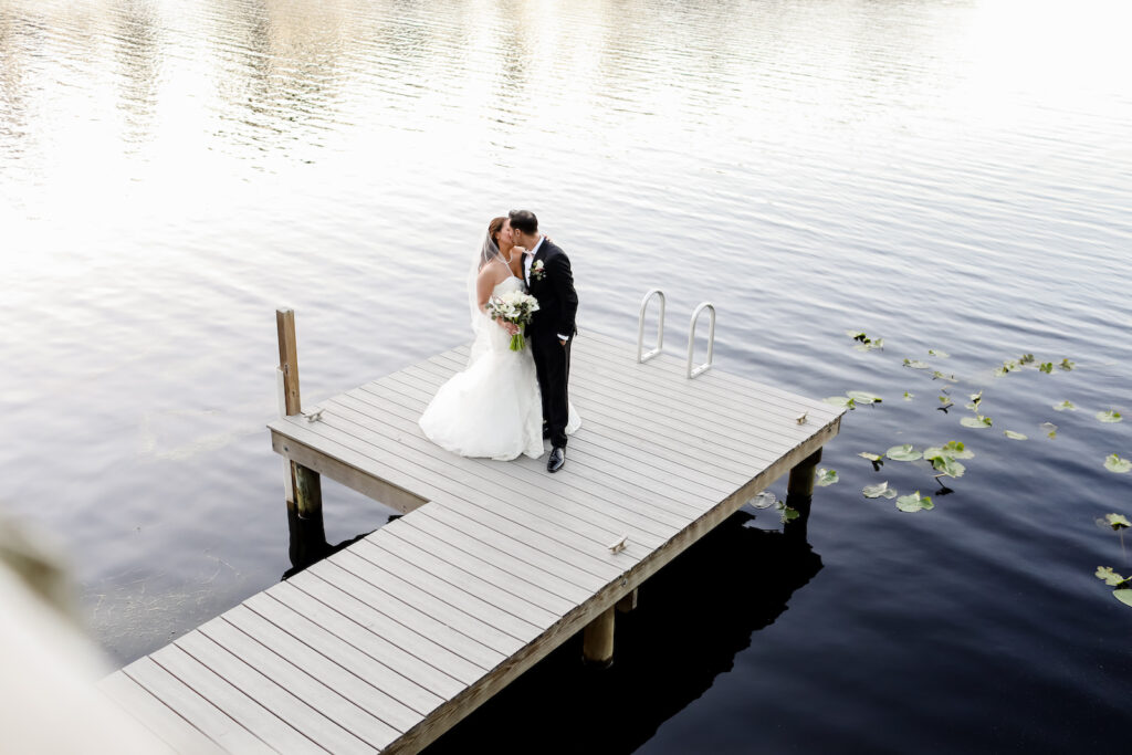 Romantic Groom and Bride Kissing On Boat Dock | Tampa Bay Wedding Photographer Lifelong Photography Studio | Wedding Dress Truly Forever Bridal | Planner Special Moments Event Planning