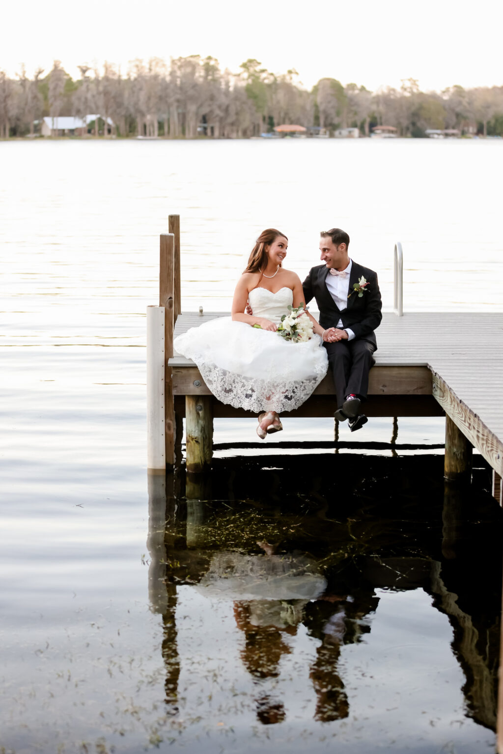 Romantic Groom and Bride Sitting On Boat Dock | Tampa Bay Wedding Photographer Lifelong Photography Studio | Wedding Dress Truly Forever Bridal