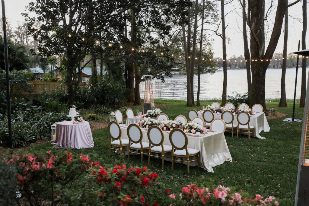 Romantic Outdoor Pink and White Wedding Intimate Reception Decor, Long Table with White Linen, White and Wooden Dining Chairs, Hanging String Lights, Floral Centerpieces, Outdoor Patio Heater | Tampa Bay Wedding Photographer Lifelong Photography Studio | Wedding Planner Special Moments Event Planning | Wedding Rentals Kate Ryan Event Rentals