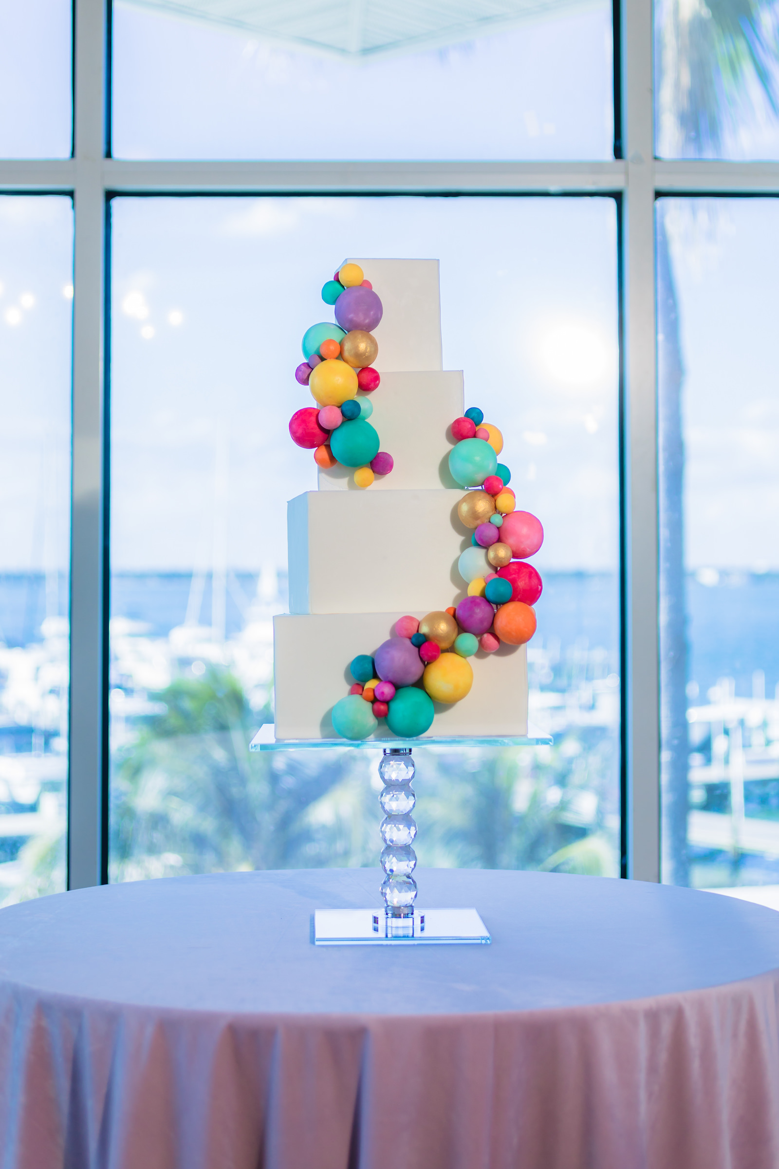 Four Tier White Wedding Cake with Colorful Round Detail Swirling Up the Cake | Wilder Mind Events | Tampa Bay Cake Company
