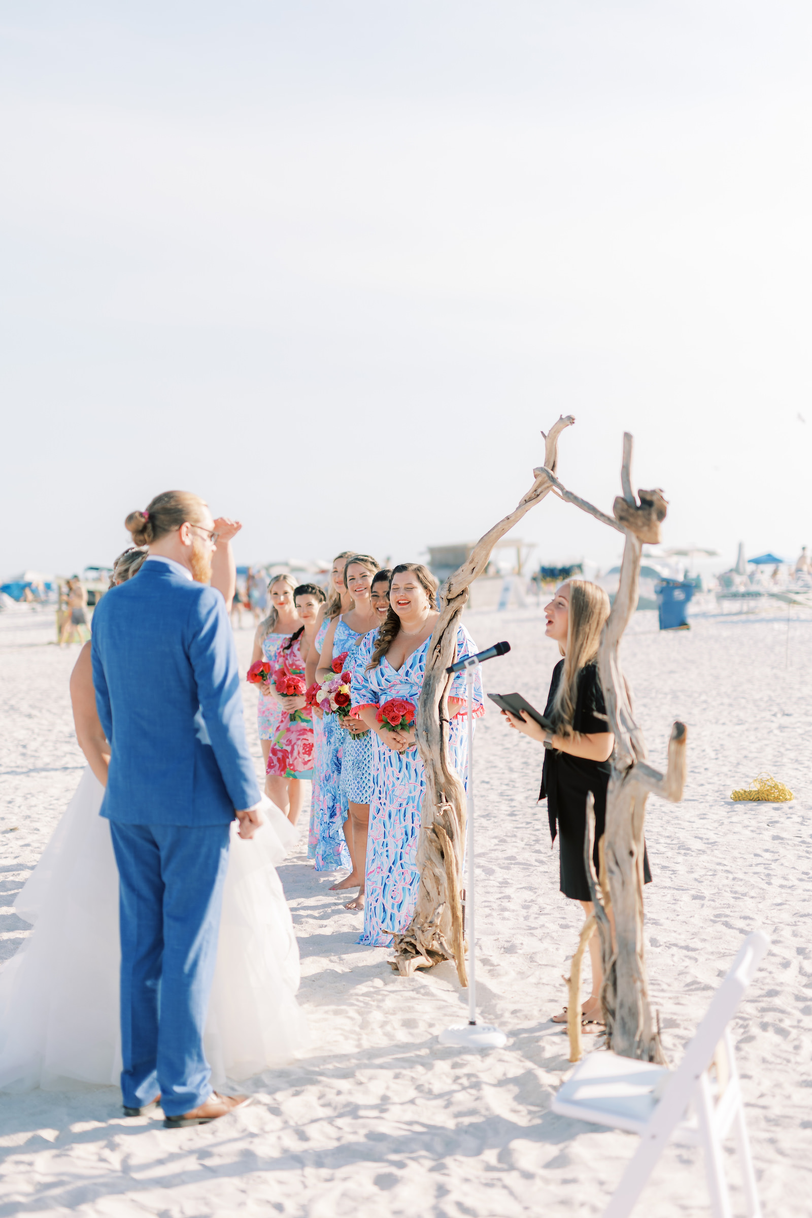 Bride and Groom Exchange Vows Wedding Portrait Under Natural Wood Arch | Florida Beach Wedding Ceremony Postcard Inn On the Beach