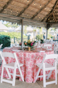 Lilly Pulitzer Inspired Tropical and Vibrant Wedding Tablescape with Pink and White Table Linen and White Chairs