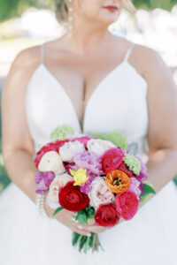 Bright and Vibrant Bridal Bouquet with Ranunculus and Roses in Shades of Pink and Orange