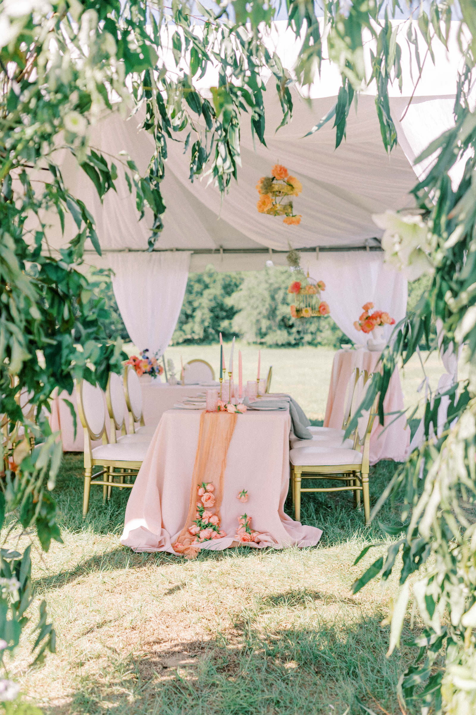 Garden Whimsical Wedding Decor, White Tent, Table with Blush Pink Table Linen, Coral Cheese Cloth Table Runner, Hanging Orange Flower Bouquets, Louis Chairs | Outdoor Nature Tampa Bay Wedding Venue Mill Pond Estate | Wedding Chair Rental Kate Ryan Event Rentals