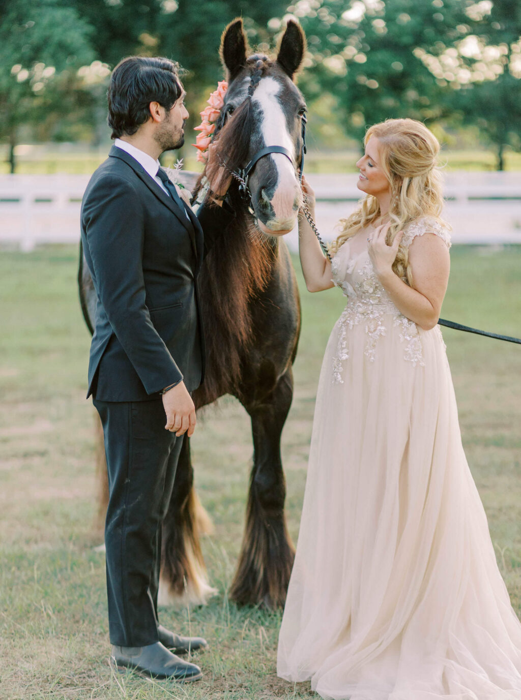 Bride Wearing Blush Pink Boho Off White Flowy Lace High Neck Wedding Dress and Groom Petting Brown and White Horse | Tampa Bay Wedding Venue Mill Pond Estate