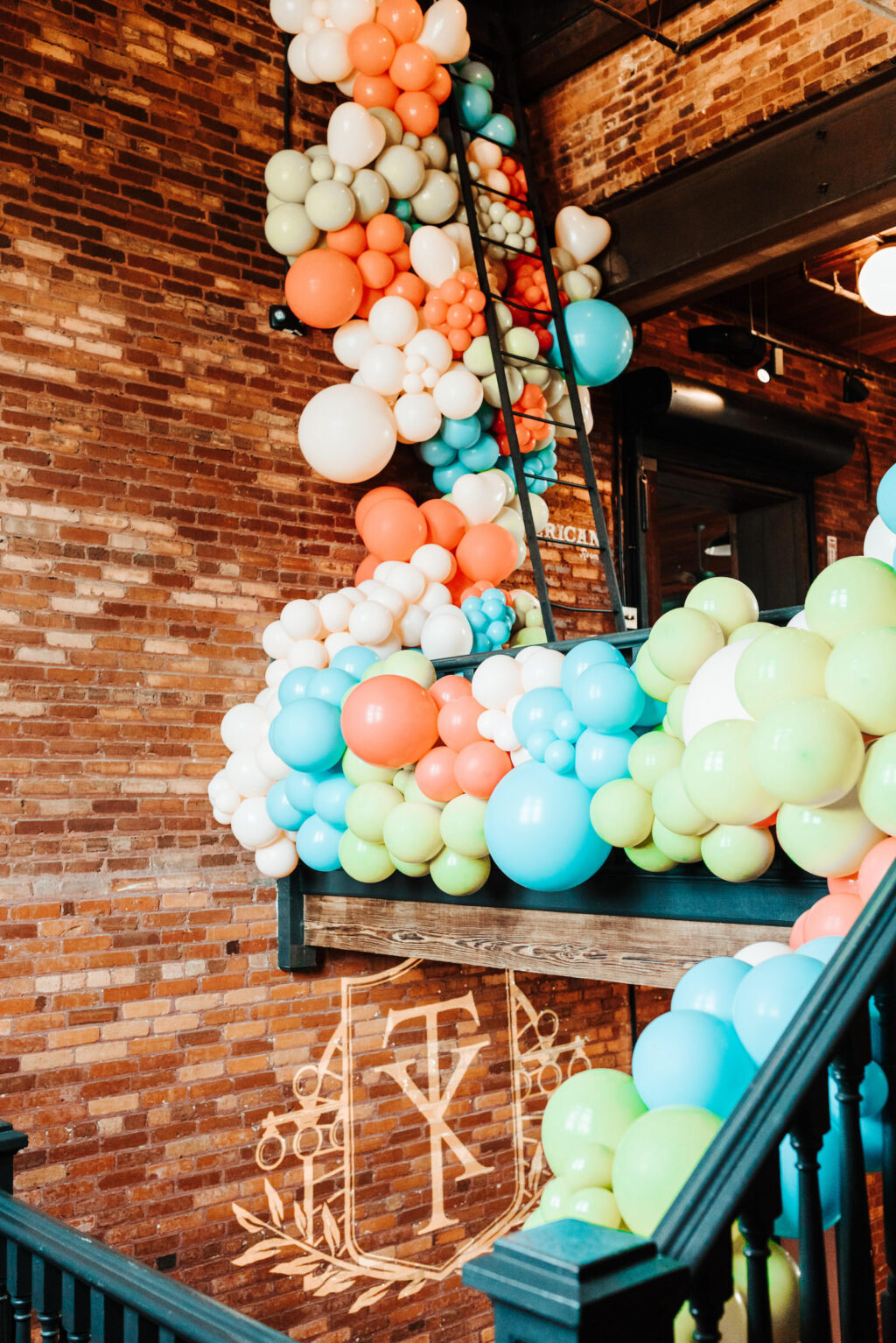 Whimsical Vibrant Blue, Green and Orange Balloon Wall Ideas for Industrial Wedding Venue | JC Newman Cigar Factory Tampa Florida Venue