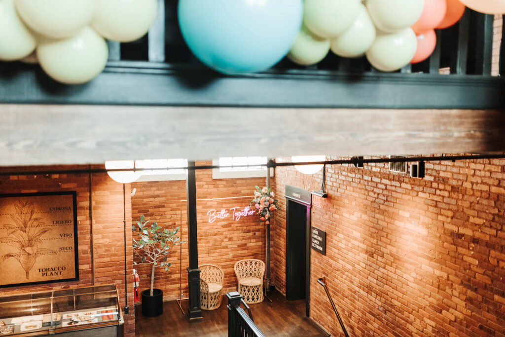 Whimsical Vibrant Blue, Green and Orange Balloon Wall Ideas for Industrial Wedding Venue | JC Newman Cigar Factory Tampa Florida Venue