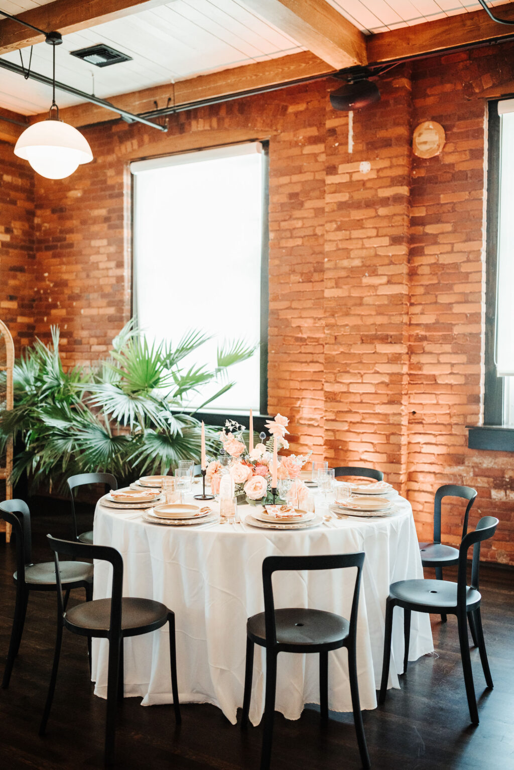 Industrial Indoor Wedding Reception White Linens, Black Metal Chairs, and Red Brick Walls | JC Newman Cigar Factory Tampa Florida Wedding Venue