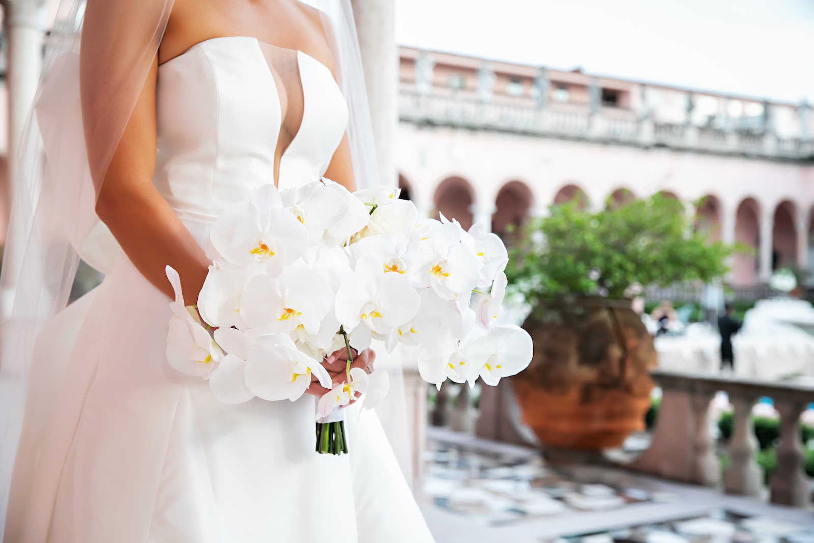 Luxurious Modern Bride Holding All White Orchid Floral Bouquet | Tampa Bay Wedding Photographer Limelight Photography