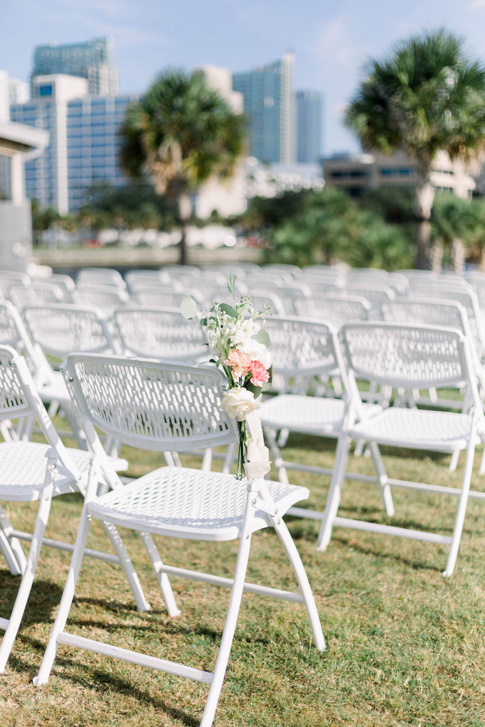 White Ceremony Chairs with Pink and White Floral Details | Tampa Rentals Kate Ryan Event Rentals