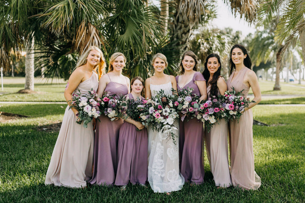 Florida Bride Holding Lush White Anemone, Purple and Pink Roses and Greenery Floral Bouquet, Bridesmaids Wearing Mix and Match Mauve and Taupe Dresses | Tampa Bay Wedding Photographer Amber McWhorter Photography | Wedding Florist Leaf It To Us