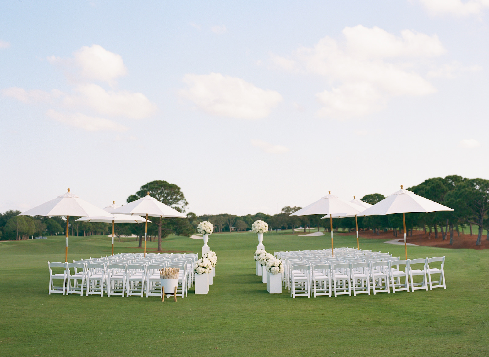 Luxurious Formal Outdoor All White Wedding Ceremony Decor on Golf Course, White Umbrellas | Tampa Bay Wedding Venue Pelican Golf Club | Wedding Planner Parties A'la Carte | Wedding Rentals Gabro Event Services