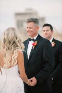 Groom Looking at Bride While Exchanging Wedding Vows During Wedding Ceremony Portrait