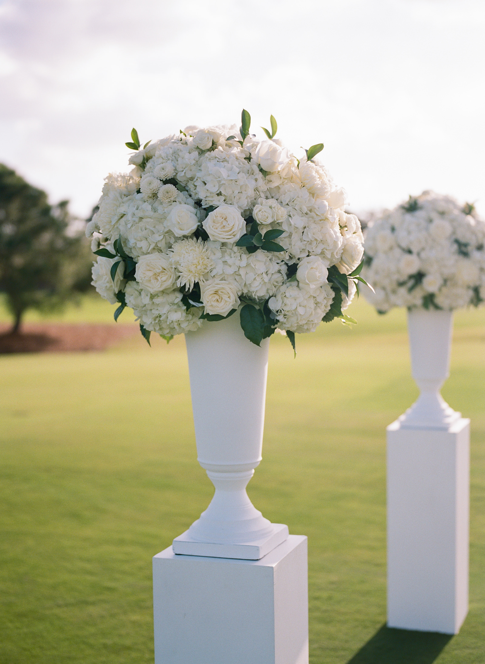 Luxurious Formal Outdoor All White Wedding Ceremony Decor on Golf Course, White Vase with White Roses, Hydrangeas Floral Arrangement | Tampa Bay Wedding Venue Pelican Golf Club | Wedding Florist Bruce Wayne Florals | Wedding Planner Parties A'la Carte | Wedding Rentals Gabro Event Services