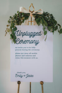 Modern Minimalist Wedding Ceremony Decor, Unplugged Sign with Greenery Arrangement