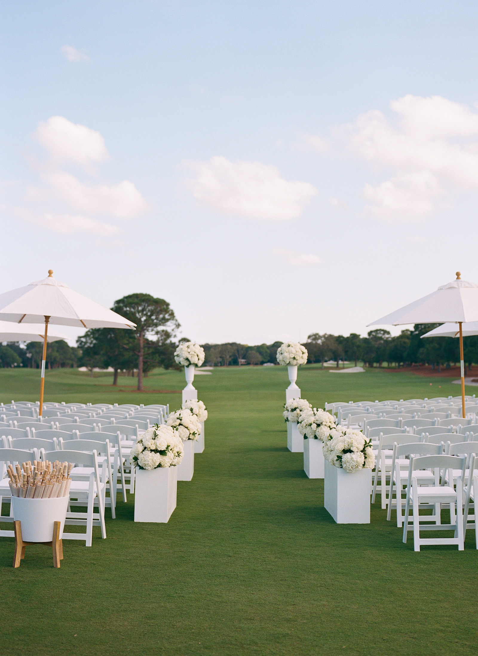 Luxurious Formal Outdoor All White Wedding Ceremony Decor on Golf Course, White Umbrellas | Tampa Bay Wedding Venue Pelican Golf Club | Wedding Planner Parties A'la Carte | Wedding Rentals Gabro Event Services