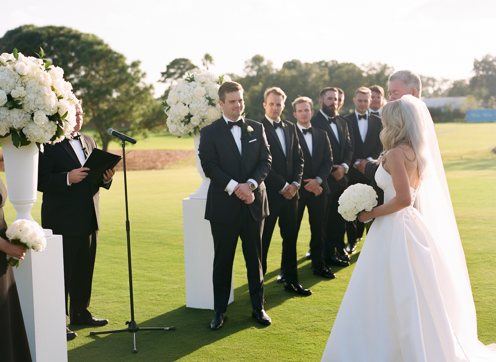 Luxurious Black and White Formal Wedding Ceremony, Bride Walked by Father, Groom and Groomsmen in Black Tuxedos | Tampa Bay Wedding Florist Bruce Wayne Florals