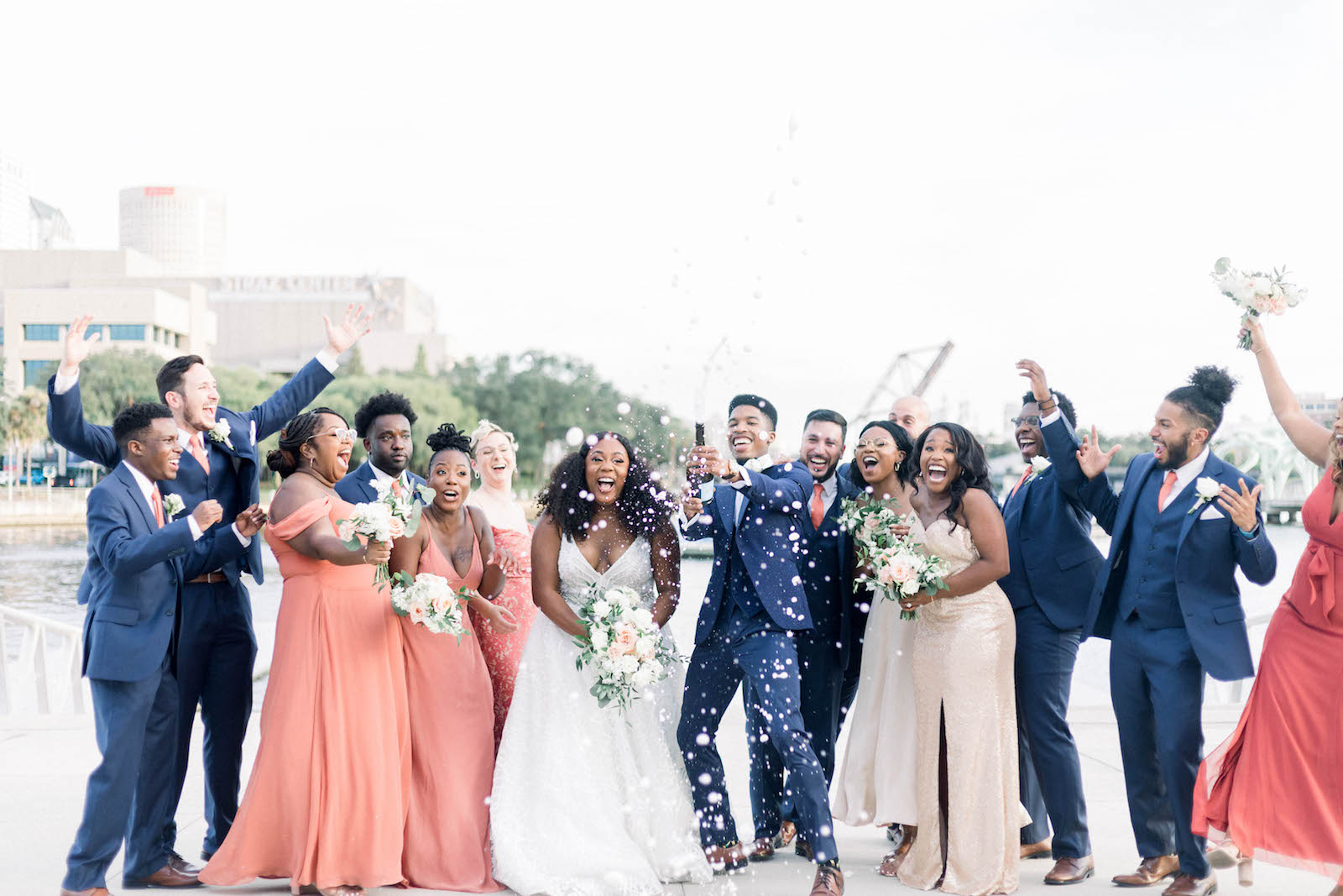 Bride and Groom Popping Champagne with Bridal Party in Downtown Tampa | Hillsborough River