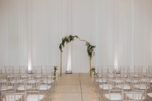 Modern Minimalist Wedding Ceremony Decor, White Draping, Crystal Chiavari Chairs, Unique Arch with Greenery and White and Blush Pink Roses Arrangements, White Draping | Tampa Bay Wedding Chair Rentals Kate Ryan Event Rentals
