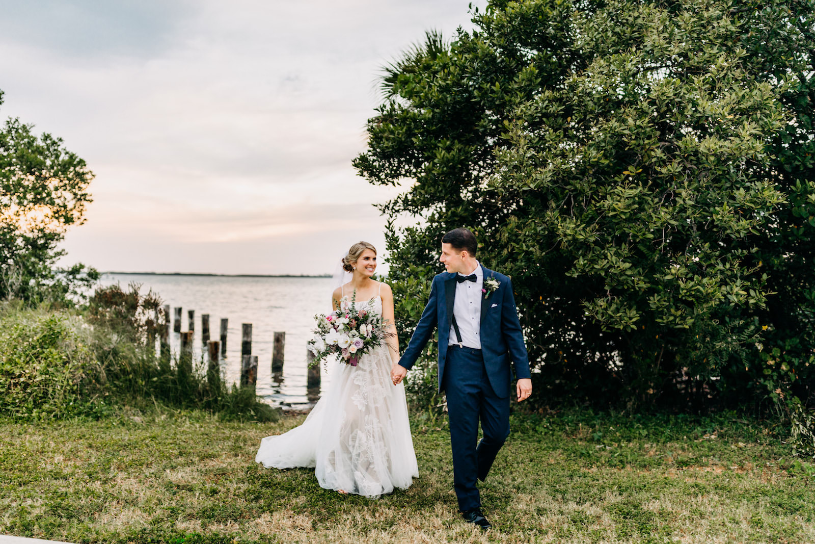 Florida Bride and Groom Walking Along Waterfront Marshes | Tampa Bay Wedding Photographer Amber McWhorter Photography