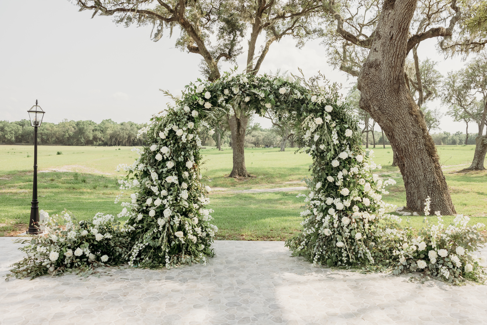 Classic Tampa Wedding Ceremony Decor, Lush Greenery and White Roses Floral Arch