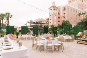 Vibrant Boho Courtyard Wedding Reception Decor, Gold Chiavari Chairs, White Linens, Low Floral Centerpieces, Hanging String Lights, Greenery Hedge Walls | St. Petersburg Waterfront Wedding Venue The Don CeSar