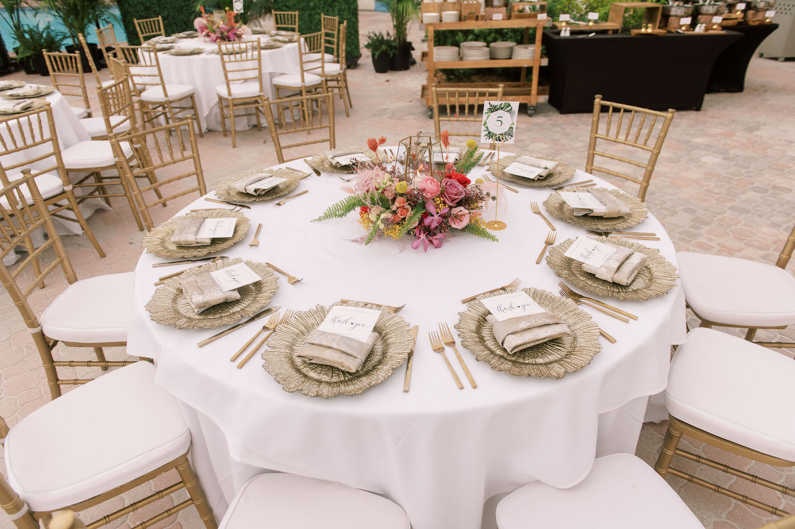 Vibrant Boho Wedding Reception Decor, White Linen Round Tables, Gold Chargers and Flatware, Low Hot Pink, Yellow and Greenery Floral Centerpiece