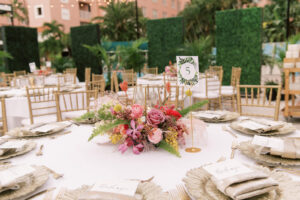 Vibrant Boho Wedding Reception Decor, White Linen Round Tables, Gold Chargers and Flatware, Low Hot Pink, Yellow and Greenery Floral Centerpiece