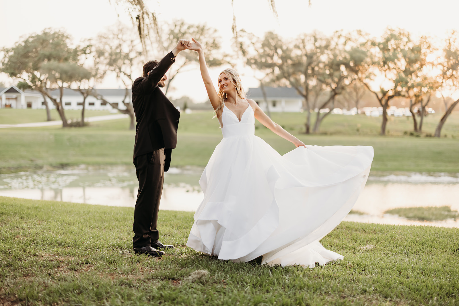 Tampa Groom Spinning Bride During Outdoor Sunset Wedding Photo