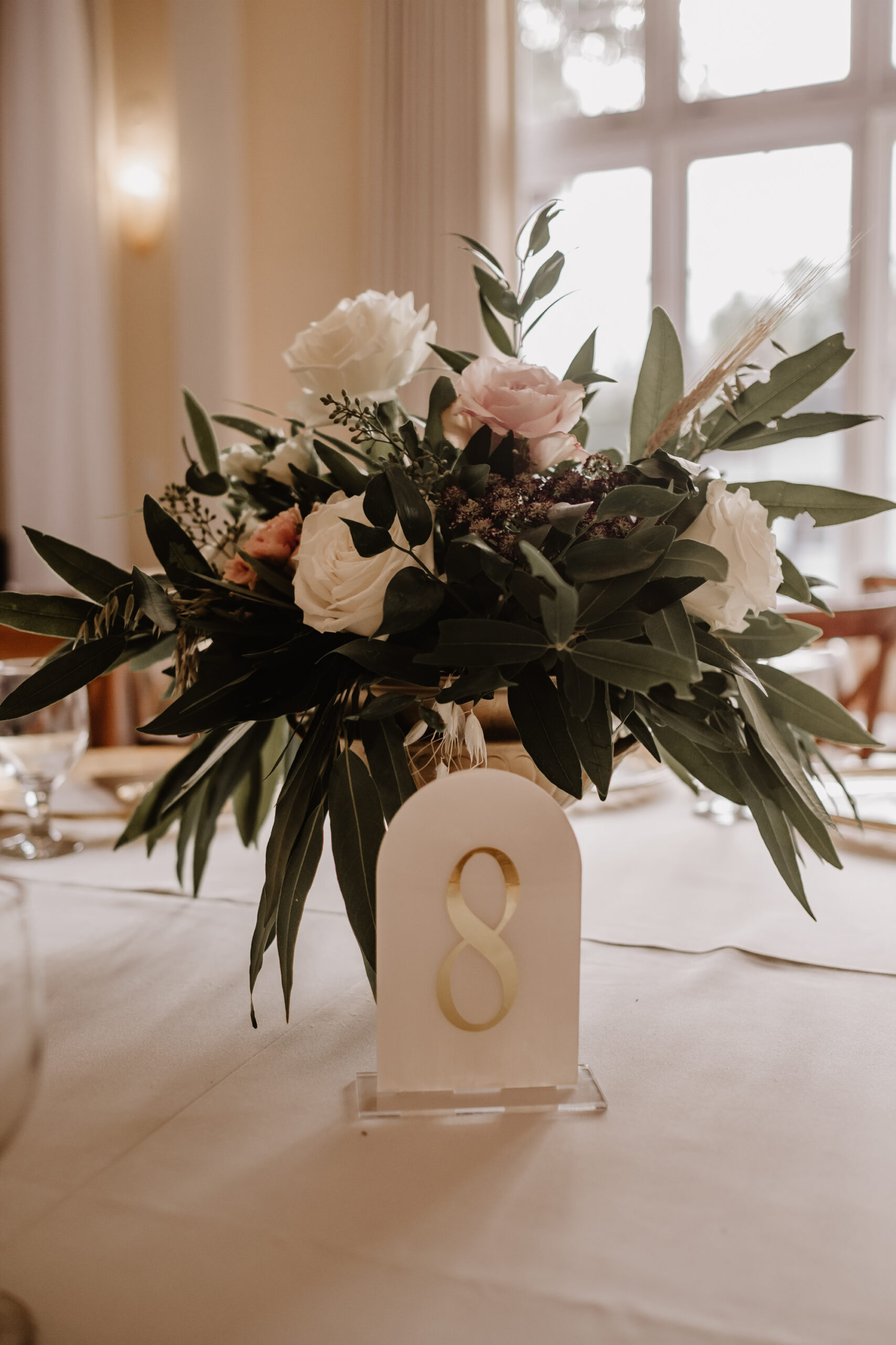 Neutral Boho Modern Wedding Reception Decor, Low Floral Centerpiece, Greenery with White and Blush Pink Roses, Acrylic White and Gold Table Number Signage | Tampa Bay Wedding Planner Taylored Affairs