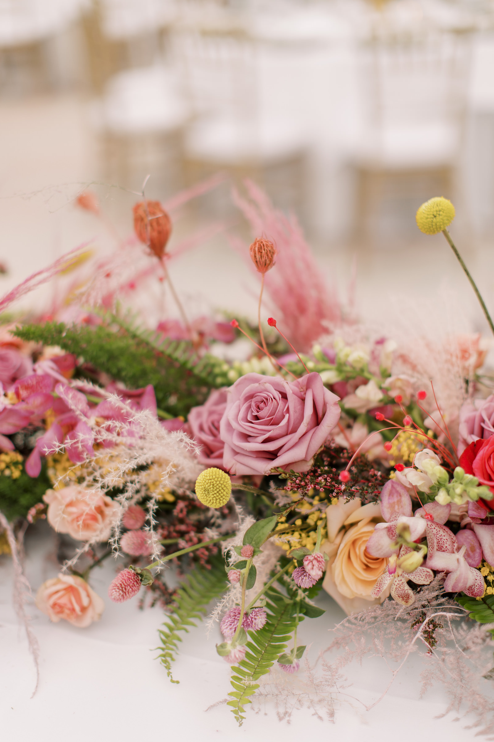 Vibrant Boho Wedding Reception Decor, Pink and Yellow Roses, Greenery Leaves, Pink Pampas Grass, Craspedia Billy Balls Floral Centerpiece