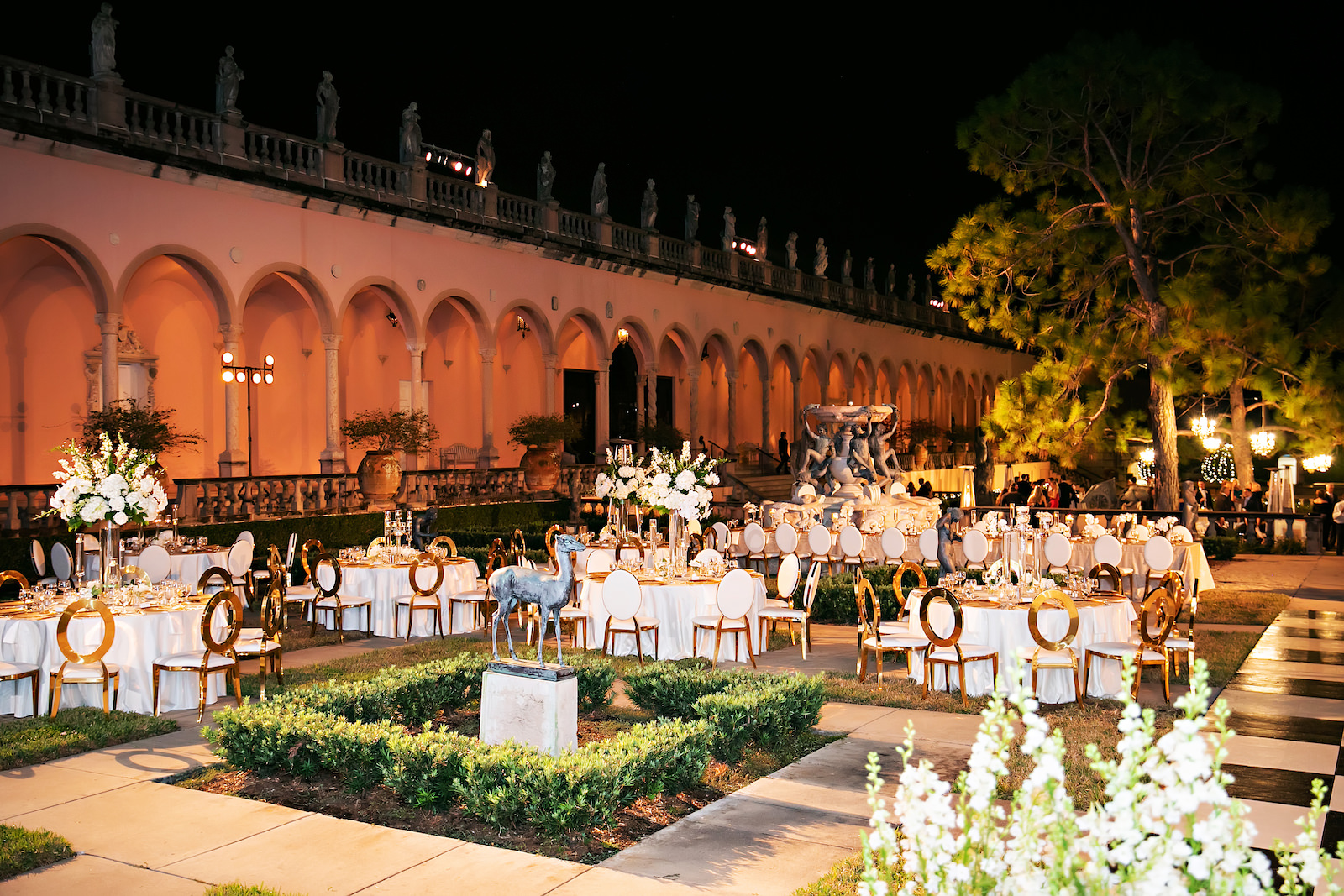 Luxurious Modern Chic Courtyard Wedding Reception Courtyard Wedding Decor, Purple Uplighting, Gold and White Chairs, Black and White Checkered Dance Floor | Tampa Bay Wedding Photographer Limelight Photographer | Sarasota Wedding Venue Ringling Museum