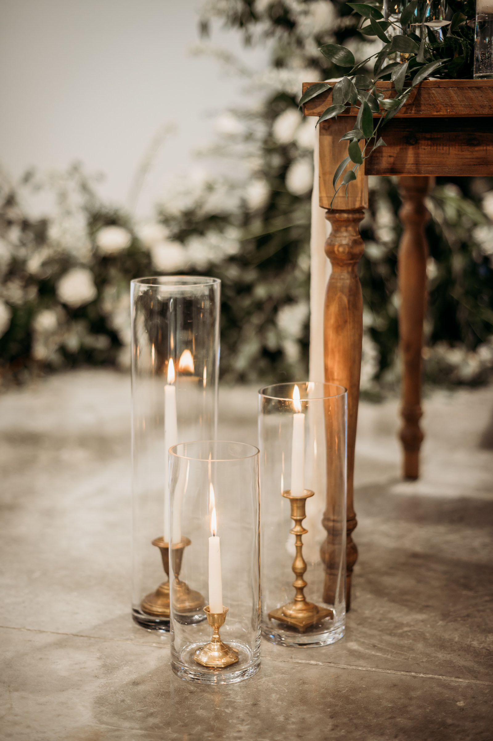 Gold Candlesticks in Hurricane Tumblers Wedding Reception Decor
