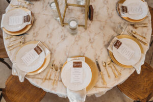 Wooden Place Cards and Menus on White Places and Gold Chargers with Gold Flatware Wedding Tablescape