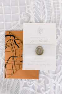 Burnt Orange Envelope with White Wedding Invitation with Gold Seal and Custom City Map
