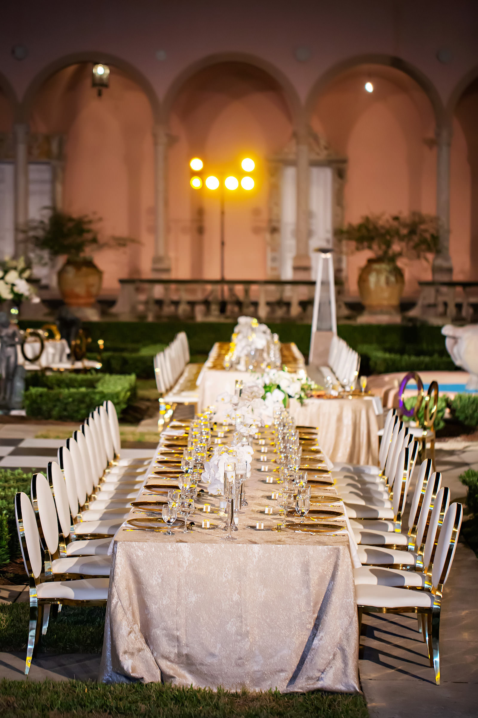 Luxurious Modern Chic Wedding Reception Decor Wedding Party Head Table, Champagne Table Linen, White and Gold Chairs, Purple Uplighting, White and Greenery Floral Centerpieces | Tampa Bay Wedding Photographer Limelight Photography | Sarasota Wedding Venue Ringling Museum