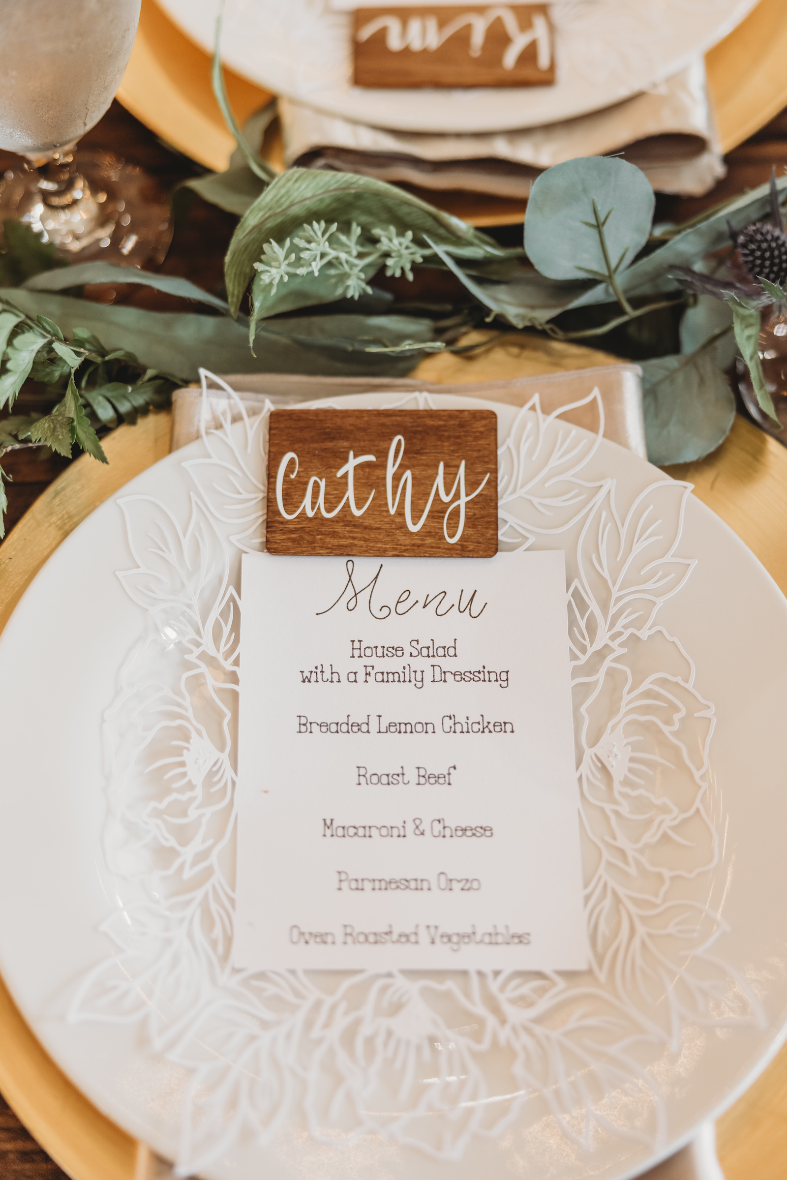 Wooden Place Cards and Menus on White Places and Gold Chargers with Gold Flatware Wedding Tablescape
