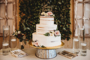 Three Tier Rustic Semi Naked Wedding Cake with Pink Rose Floral Detail and Greenery